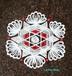 an intricate design on the ground in white and red