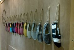 a row of purses hanging on a wall