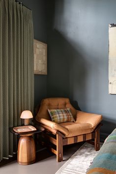 a living room with a chair and ottoman