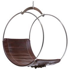 two circular chairs hanging from chains in the shape of an egg - shaped swing chair