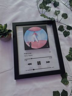 an image of a person playing music on the screen in front of some plant life