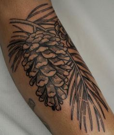 a black and white photo of a pine cone tattoo