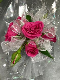 a bouquet of pink roses sitting on top of a table