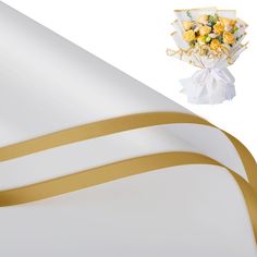 a bouquet of yellow roses is next to a white background with gold ribbon on it