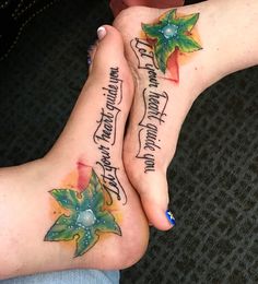 two people with tattoos on their feet holding each other's hands and both have words written on them