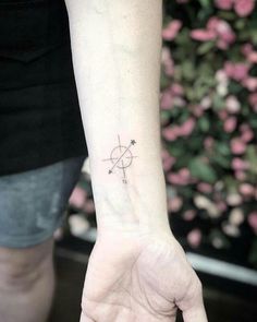 a woman's wrist with a small star tattoo on her left hand and the other arm