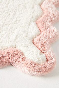 a pink and white rug on top of a table