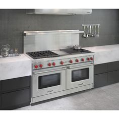 a stove top oven sitting inside of a kitchen next to a counter with two burners