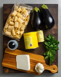 the ingredients for this dish include eggplant, cheese, and sauces on a cutting board