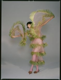 a woman in a green and pink costume