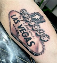 the las vegas sign has been tattooed on someone's arm