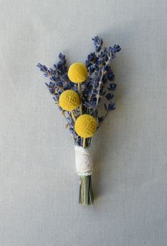 a bunch of flowers sitting on top of a white table next to a blue wall