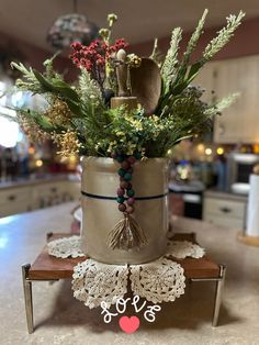 a vase filled with lots of flowers on top of a table