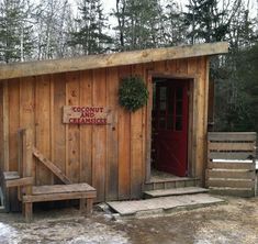 a small wooden building with a red door and sign on the side that says coconut no chance