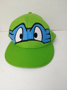 Teenage Mutant Ninja Turtles Fitted Hat age 14+ Size 7 3/8 Green. Shipped with USPS First Class. Adjustable Green Novelty Costume Hat, Adjustable Themed Green Hat, Adjustable Green Themed Hat, Adjustable Green Fun Costume Hats And Headpieces, Green Adjustable Fun Costume Hats And Headpieces, Casual Snapback Hats For Playtime, Green Adjustable Costume Hats And Headpieces, Novelty Green Adjustable Hat, Adjustable Green Novelty Hat