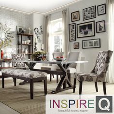 a dining room table and chairs with pictures on the wall behind them in an elegant setting