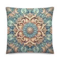 a decorative blue and beige pillow with an intricate flower design on the front, in pastel tones