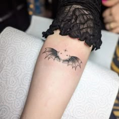 a woman with a bat tattoo on her arm