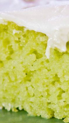 a piece of green cake with white frosting on it's top and bottom