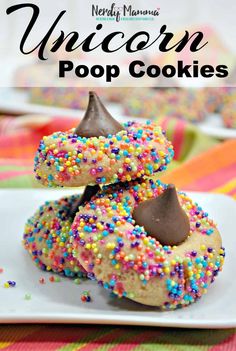 unicorn pop cookies on a white plate with sprinkles