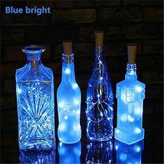 three bottles with lights in them sitting on a table next to each other and the words blue bright