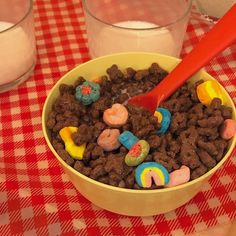 a bowl filled with cereal sitting on top of a red and white checkered table cloth