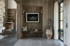 an entry way with wood paneling and stone walls, along with a bench in the center