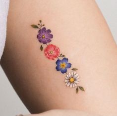 a woman's thigh with flowers painted on it