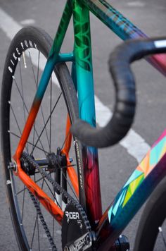 a colorful bicycle parked on the side of the road