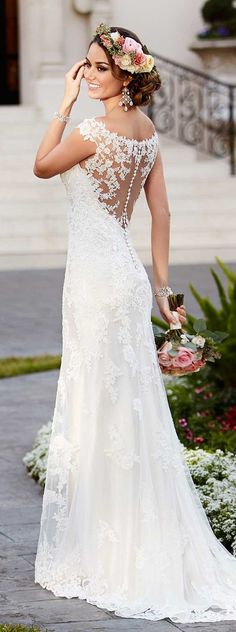 a woman in a wedding dress is walking down the street with her hand on her head