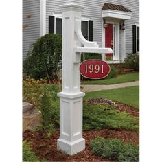 a white mailbox with a red door and address sign in front of a house