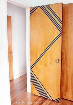 an empty room with wooden doors and hard wood flooring