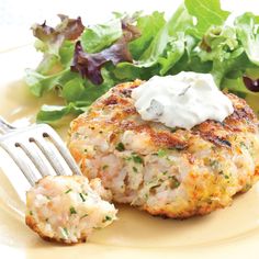 a plate with crab cakes and salad on it