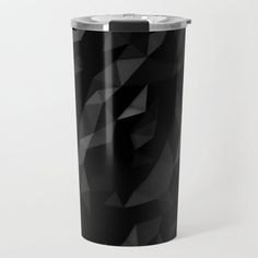 a black tumbler cup sitting on top of a white table