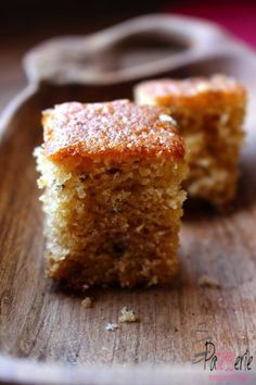 two pieces of cake sitting on top of a wooden plate