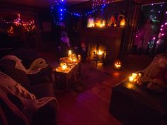 a living room filled with furniture and lit candles