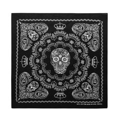 a black bandanna with a white skull on the front and an ornate border around it