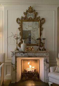 a living room with a fire place in the center and a mirror on the wall