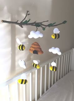 a baby crib with bees hanging from it's side and the words, bee on