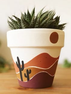 a potted plant sitting on top of a wooden table