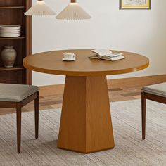 a wooden table with two chairs and a book shelf