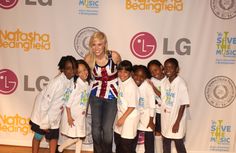 a woman standing in front of a group of children