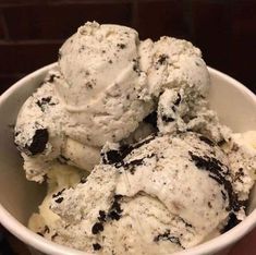 three scoops of ice cream in a white bowl