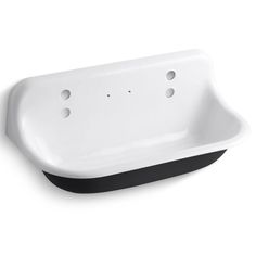 a white sink sitting on top of a counter next to a black and white wall