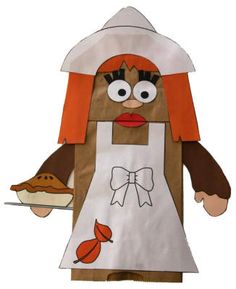 a paper doll with an apron and hat holding a pie on a plate in her hand