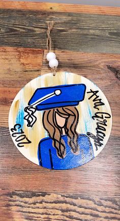 a wooden ornament with an image of a woman holding a baseball bat on it