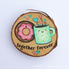 a wood slice with a doughnut and coffee mug on it that says together forever