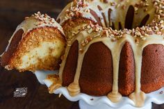 a bundt cake with frosting and nuts on top