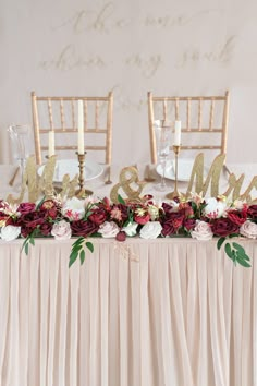 the table is decorated with flowers and gold letters