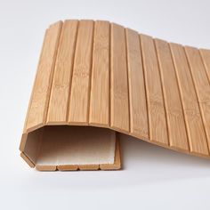 a close up of a bamboo mat on a white surface with an opening in the middle